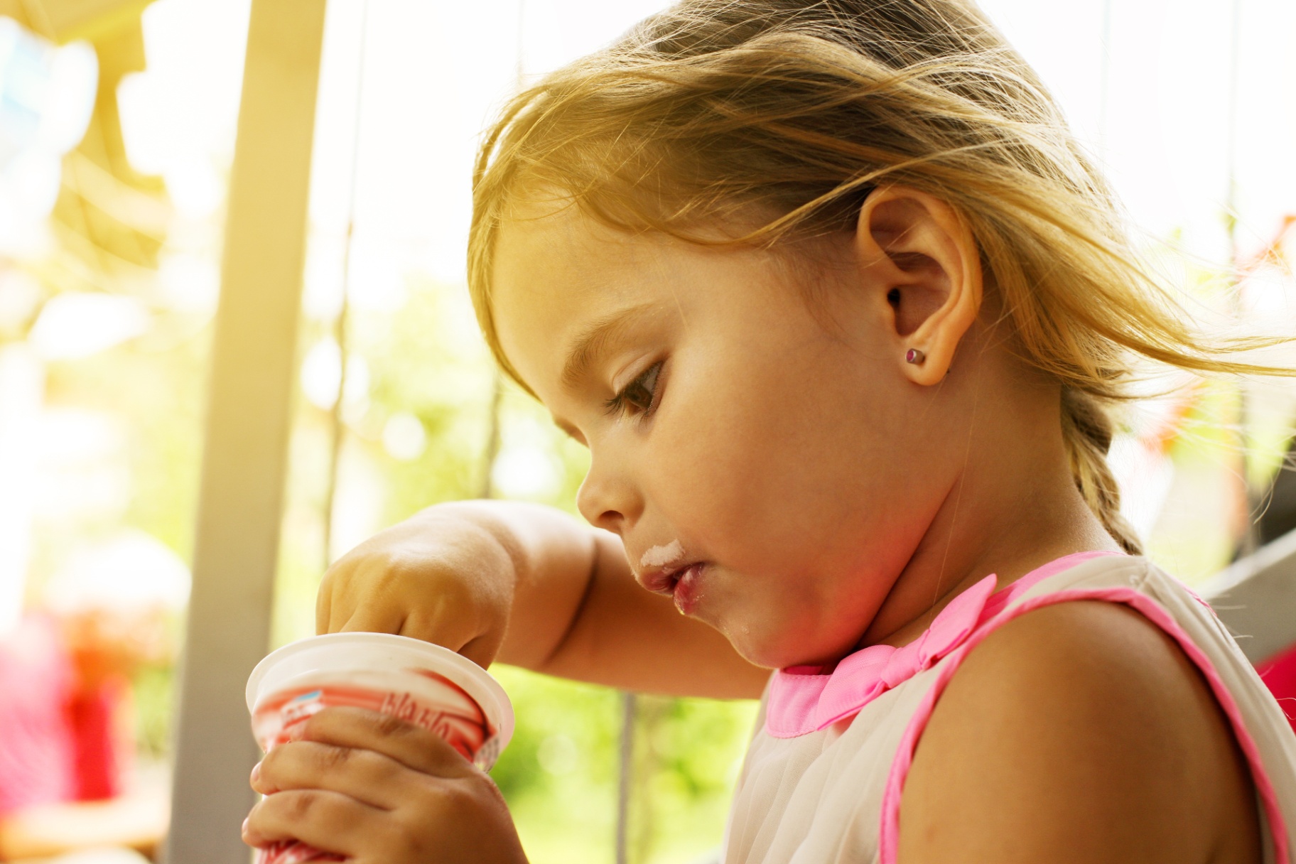 Kid eating dairy from a cup